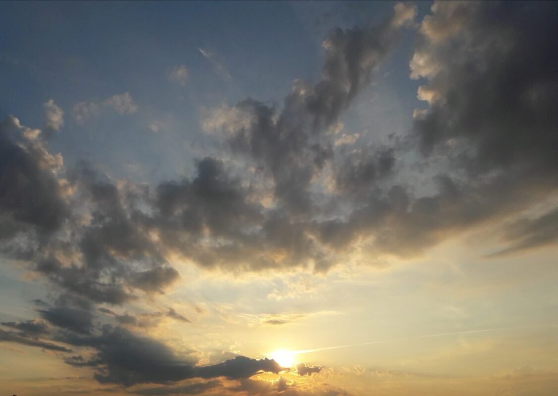 A soft sunrise breaking through clouds.